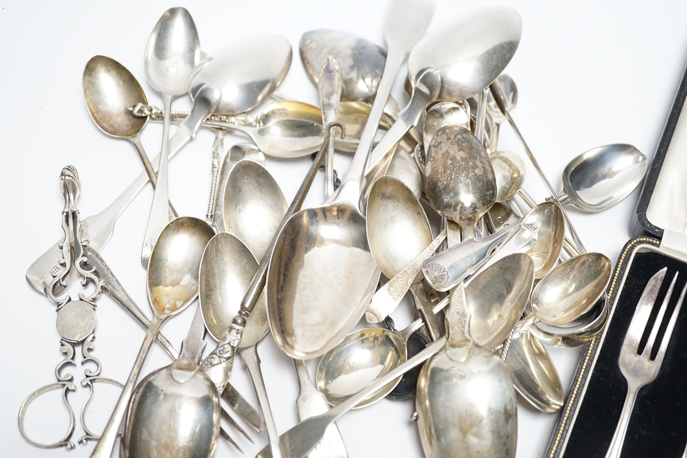 A quantity of assorted 19th century and later silver flatware, various dates, patterns and makers including a pair Georgian sugar nips, 30.2oz.